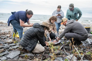 Randy Blood (far right) shows students how to properly wrap a core after it has been extracted.