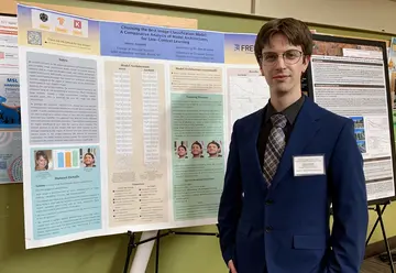 SUNY Fredonia alumnus Henry Zelenak, ’23, with his poster at the IEEE Western New York Signal Processing Workshop.