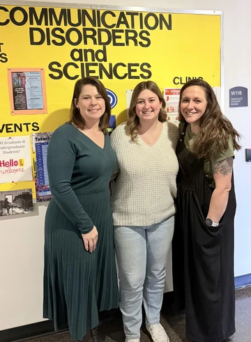 Hannah Belknap with two faculty members