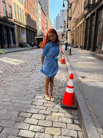 Jada standing on a brick street