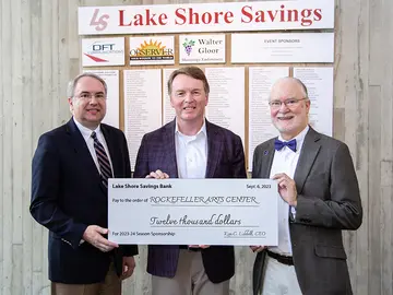 university staff and bank CEO with check