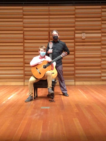 student Charles Mossey with Professor James Piorkowski with guitars