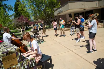 students playing instruments in courtyard