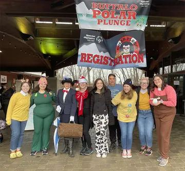 Showing all smiles, before their dip into wintery cold water at the 2023 Buffalo Polar Plunge, are (from left): Haley Fenik, Savannah Salim, Dr. Janeil Rey, Alexis Adamski, Holly Rohrbach, Dr. Michael Jabot, Alexandrea Simmons, Kennedy Neckers and McKenzie Lohmer.