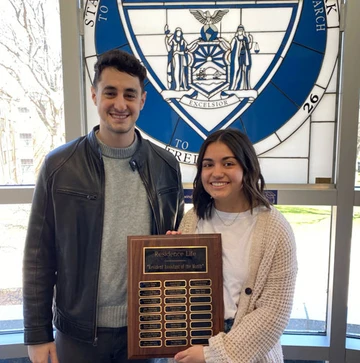 Regan Walton and Resident Director with plaque