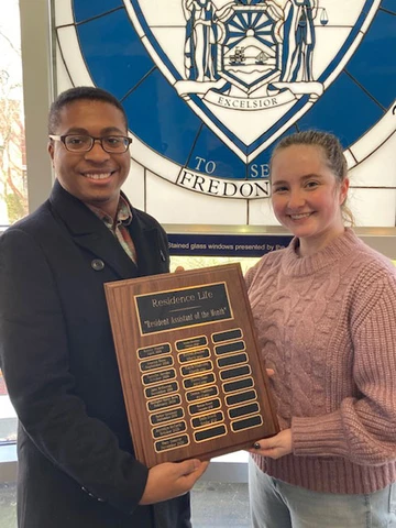 Emilia Driscoll displays her award with Resident Director Christopher Shirley-Brown.