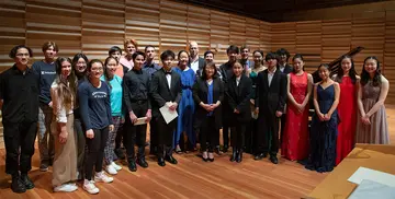 Students and School of Music faculty participating in the 2022 Sorel Piano Competition and Fellows Program gather for a group photo on the Rosch Recital Hall stage.