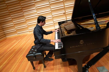 Zarin Mehta performs on the piano in Rosch Recital Hall.