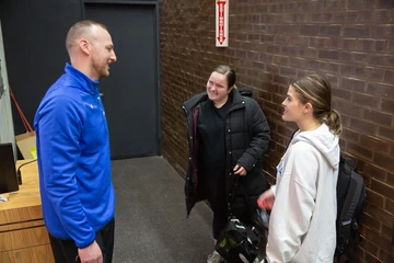 Scott Bergen talks to two students after a class talk he gave.