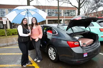 Hannah Suchanick (left) and Holly Rohrbach, with their car loaded with suitcases, near University Commons on the day before they started driving to Texas for their student teacher placements.