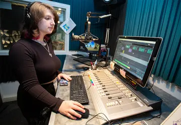 student at radio station board