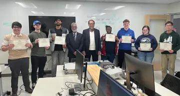 students with their teachers and holding certificates