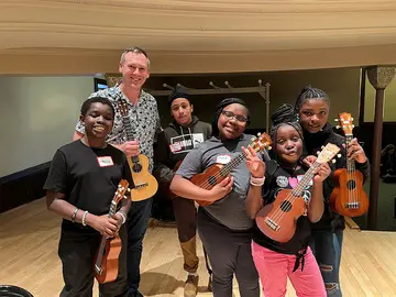 Zachary Arenz and his students with ukuleles