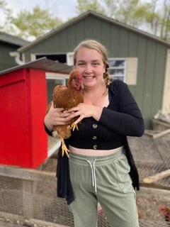 Abby Hart, with Clairee, one of the family chickens