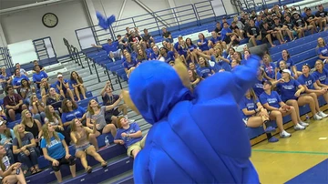 Fredonia mascot tosses gifts into bleachers toward students