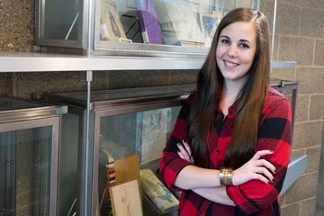 Catherine Oag, outside of the archives in Reed Library, where she is serving an internship.