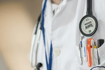 person in white physicians jacket