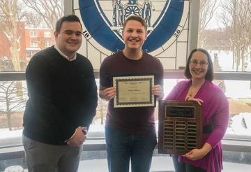 Nolan Ahearn, recipient of the November Student of the Month award, with Patrick Toscano and Kate Huff.