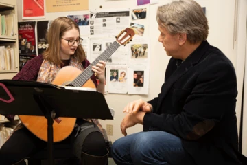 Allison DiMauro, with guitar professor James Piorkowski, during a lesson in Mason Hall.