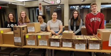 students with boxes of donations