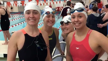four female swimmers on the pool deck, swimming and diving, women's swimming and diving