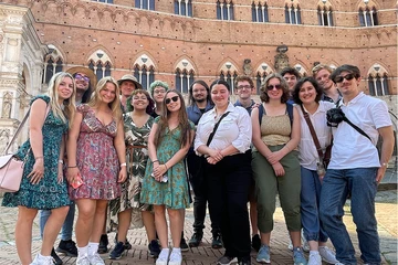 Gathering for a group photo in Siena in the Piazza del Campo are students., Lillian Baer, Isabella Read, Megan Kenny, Alisa Mazon, Gianna Pillitteri, Lilian Holman and Henry Domst; (back row): Angelo Petrilli, James Keller, Jakob Cullen, Ethan Brooks, Devon Kennedy, Andrew Johnson and Benjamin Evans.