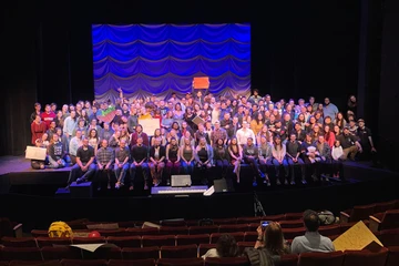 cast, faculty and staff of musical on stage