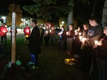 Participants in Sunday's Vigil for Peace at the Peace Pole on campus.