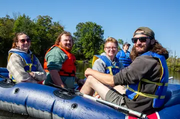 STEM students in Biological Sciences do research out on the lake 
