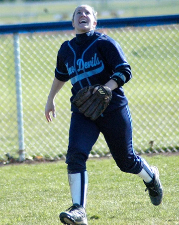 Hall of fame softball player Heather Mercer tracks down a fly ball during a game