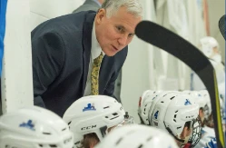 hockey coach Jeff Meredith instructs his players during a game
