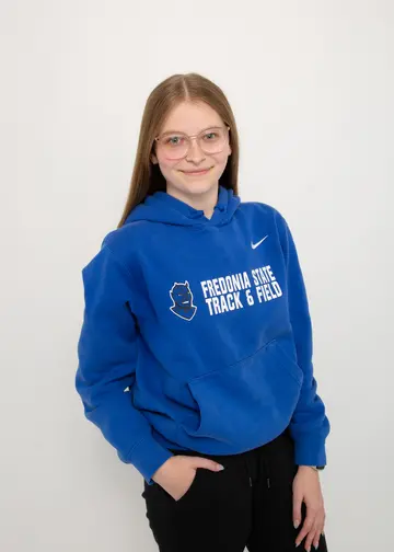 Student in the College of Liberal Arts and Sciences Haley Mercer in their Fredonia hoodie