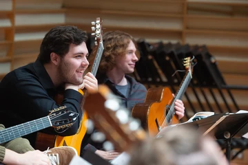 Fredonia guitar students getting hands on with the guitars. 