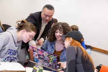Fredoni students in a classroom working closely with a professor. Students enjoy a low student to faculty ratio, meaning your professor usually knows your name. 