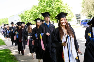 Graduates marching toward the graduation ceremony. Students at Fredonia can major in math to get great degrees in actuarial science and work with data  