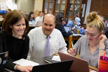 Faculty and students working together in a classroom