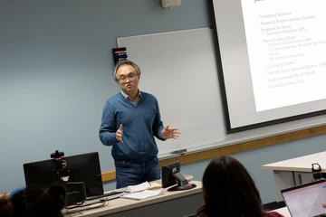 professor in front of class talking to history students