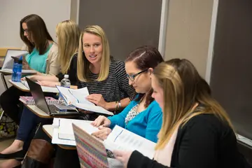 Liberal arts students in English studying a text in a group