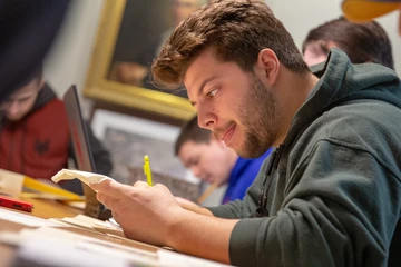 History major engaged with a project in class