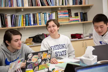 Math students working on problems in the math fishbowl while earning a graduate degree in math.