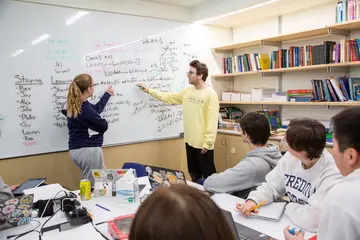 Liberal arts students leading a math class, literally solve problems