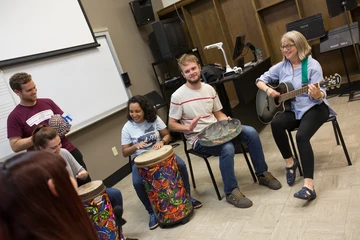 music therapy students in class playing music together