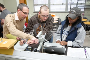 Students and professor in a classroom. Fredonia physics major collaborates with accomplished faculty member on groundbreaking research.