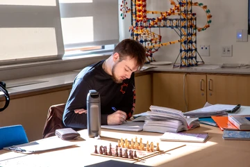Student studying at a table. Cooperative engineering students access world-class facilities without the Ivy League price tag.