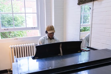 student practicing in a practice room in Mason hall