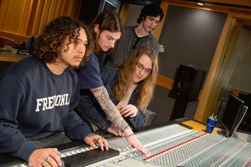 Students misxing music in a studio
