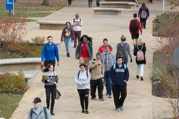 Fredonia students enjoy a breezy fall day walking across campus  
