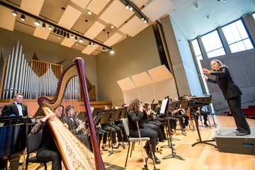 the wind ensemble performing in the Rockefeller Theatre 