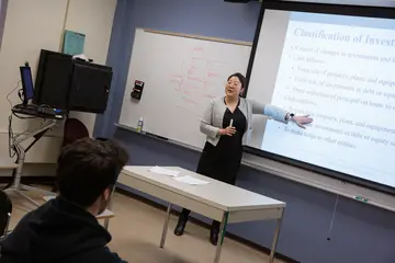 A Fredonia professor teaching a business class. Students can earn a degree in accounting  in our accounting degree program.