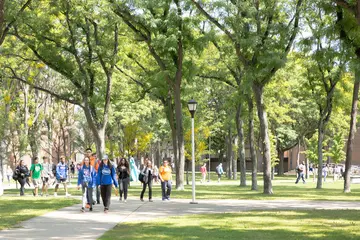 typical summer day on the fredonia campus with students walking under trees